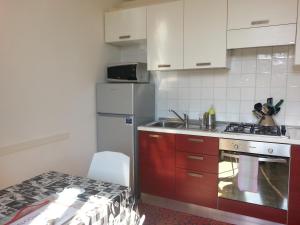 a kitchen with a sink and a stove top oven at Between Termini & Colosseo in Rome