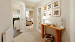 a living room with a table and a living room at Creel Cottage, Lower Largo in Lower Largo