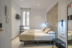 a bedroom with a bed with two pillows on it at Comfortable Room close to City Centre in Valencia