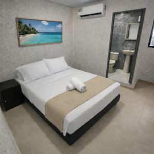 a bedroom with a large bed with a view of the ocean at HOTEL COSTA AZUL SAI in San Andrés +7 photos
