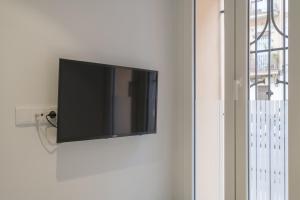 a flat screen tv hanging on a wall at Comfortable Room close to City Centre in Valencia