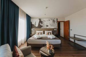 a hotel room with a bed and a couch at Timbre Heroismo in Porto +79 photos