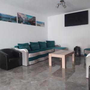a living room with a couch and a table at Casa Ardelean in Sita Buzăului