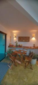 a room with a table and two chairs and a counter at Pousada Atlantik-Haus in Costa Dourada