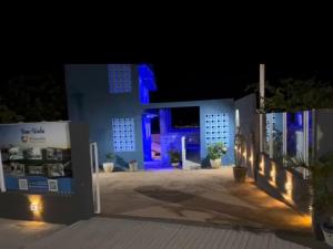 a building with blue lights on it at night at Pousada coração da serra in Serra de São Bento