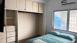 a small bedroom with a bed and a window at Peace N' Green - APARTMENTS - Doleguita in David
