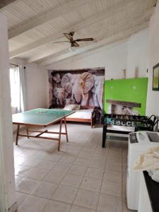 a living room with a ping pong table and a couch at blue beach in Rocha