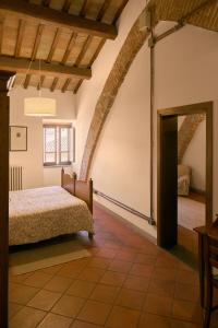 a bedroom in a house with a bed and a doorway at Residenza Antica Canonica in Città di Castello