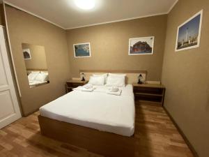 a bedroom with a bed with white sheets and pillows at Silver Hotel Budapest City Center in Budapest