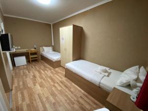 a hotel room with two beds and a desk at Silver Hotel Budapest City Center in Budapest