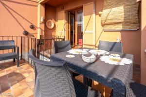 a table and chairs on a patio with flowers on it at La Casetta di Pino in Varenna