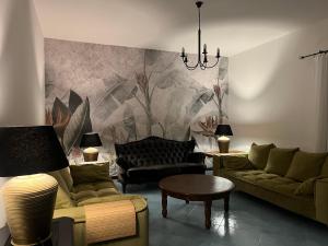 a living room with couches and a painting on the wall at Villa BellaVista in Belvedere Marittimo