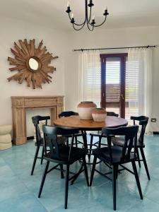 a dining room with a wooden table and chairs at Villa BellaVista in Belvedere Marittimo