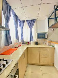 a kitchen with blue drapes and a counter top at Guest house in Addis Ababa