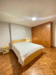 a bedroom with a large bed and wooden floors at Guest house in Addis Ababa