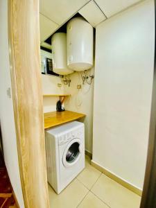 a small kitchen with a washing machine in a room at Guest house in Addis Ababa