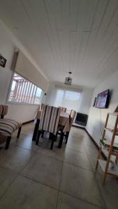 a living room with a table and chairs in it at El refugio de Marisela in Trevelín