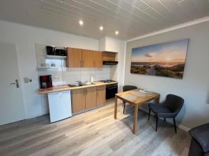 a kitchen with a table and a dining room at Meeresbrise in Norden