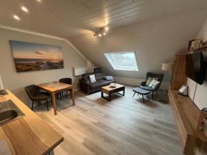 a living room with a couch and a table at Meeresbrise in Norden