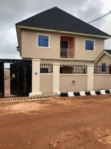 a house with a gate in front of it at Trendy Terrace in Benin City