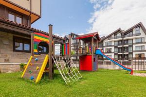 a playground with a slide in a yard at Apartments Terra Harmony - 4 star free SPA resort, Golf i Skiing in Bansko