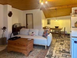 a living room with a white couch and a table at A cozy cottage in Tomar in Tomar