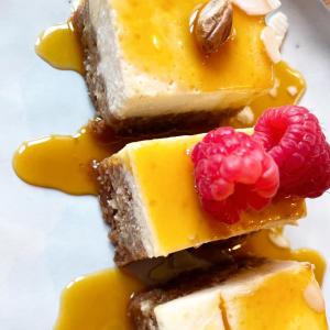a plate with three pieces of yellow cake with raspberries at Auberge La Cure in Oz