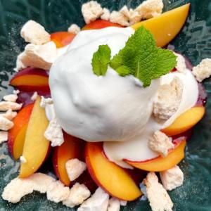 a pile of fruit with yogurt and a mint leaf on top at Auberge La Cure in Oz +35 photos