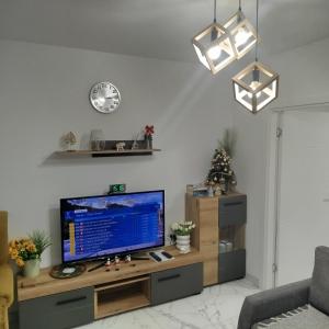 a living room with a television on a wooden table at SokoSTAR Apartman in Soko Banja