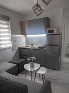 a kitchen with a couch and a table in a room at SokoSTAR Apartman in Soko Banja