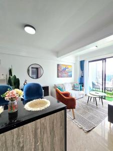 a living room with blue chairs and a couch at Padmore residence-Kilimani in Gatunga