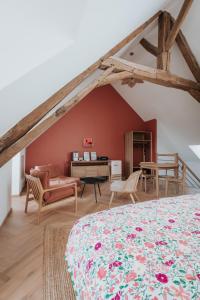 an attic bedroom with a bed and a desk at Les Cabottes in Change