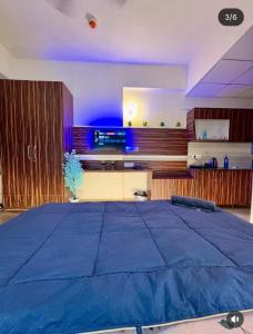 a bedroom with a large blue bed in a room at Ocean Bloomz Stay in Greater Noida