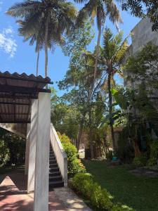 a stairway leading up to a building with palm trees at Angel Haven Villa in Mirissa
