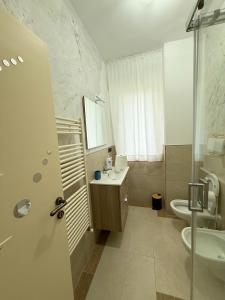 a bathroom with a sink and a toilet and a shower at Vista Mare 22 Due Camere triple o doppie in Bari +47 photos