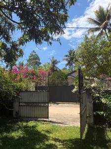 a gate in a yard with a house at Angel Haven Villa in Mirissa
