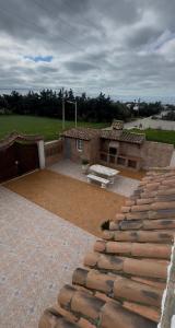 a house with a brick patio and a building at CHALET LOS PEPES in El Palmar