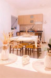 a kitchen and dining room with a table and chairs at Beach Village Rest in Tarrafal