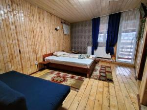 a bedroom with two beds and a wooden floor at Casa Tudor Turda in Turda