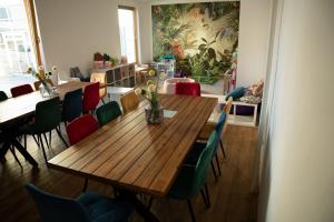 a dining room with a wooden table and chairs at Sauna Cafee & Beds in Český Těšín