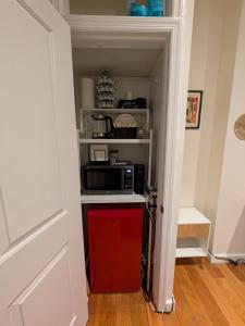 a kitchen with a microwave and a red refrigerator at Times Square Retreat with Private Bathroom and Kitchenette in New York