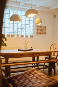 a dining room with a table and two pendant lights at Hôtel Dune Saint-Pierre in Saint-Pierre-Quiberon +19 photos