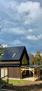 a barn with a solar roof on top of it at Izera House in Świeradów-Zdrój