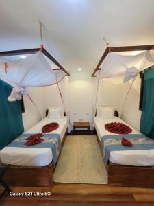 a room with three beds in a room at Unguja Lodge in Kizimkazi +71 photos