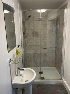 a bathroom with a shower and a sink at Stag Cottage in Ilkeston +14 photos