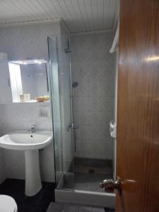 a bathroom with a sink and a shower and a toilet at Elea rooms 7 in Elia Laconias