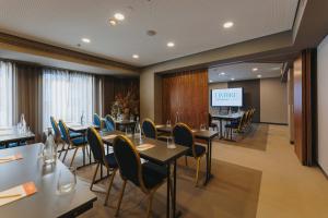 a conference room with tables and chairs and a screen at Timbre Heroismo in Porto