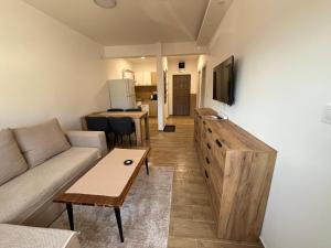 a living room with a couch and a table at Apartman Mimoza - Meljine in Meljine