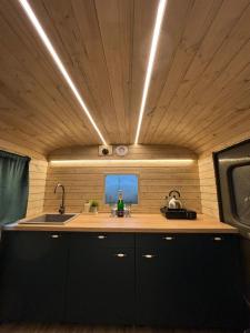 a kitchen with a sink and a counter top at Glamping Vejtřaska in Mochtín