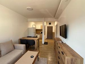a living room with a couch and a table at Apartman Mimoza - Meljine in Meljine